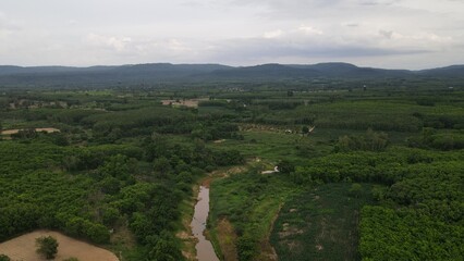 view of a river with mountains and sky in the background.