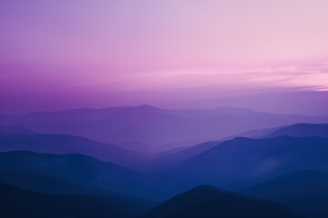 Fototapeta premium Purple mountain range fading into the distance during sunset
