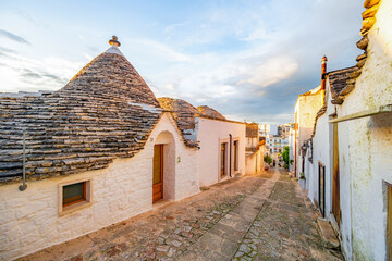 Trulli of Alberobello, Puglia, Italy. town of Alberobello with trulli houses among green plants and...