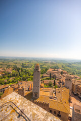 Naklejka premium Medieval San Gimignano hill town with skyline of medieval towers, including the stone Torre Grossa. Province of Siena, Tuscany, Italy.