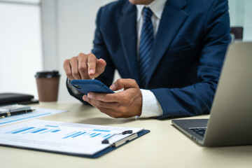 A banker in a suit works at a desk handling loans, analyzing client financial data, providing...
