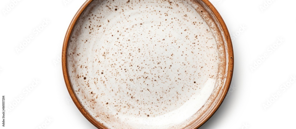 Poster single empty round ceramic plate with brown spots and edge isolated on a white background with a cli