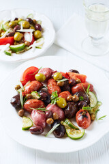 Spanish sausage with olives and fresh rosemary. Bright wooden background. Close up.
