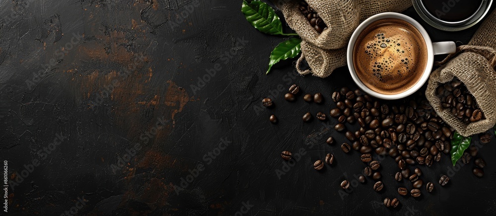 Leinwandbilder cup of coffee and coffee beans in a sack on dark background, top view. copy space image. place for a