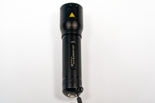 Close-up of black metal flashlight led model Lenser P7R against white background. Photo taken June 22nd, 2024, Zurich, Switzerland.