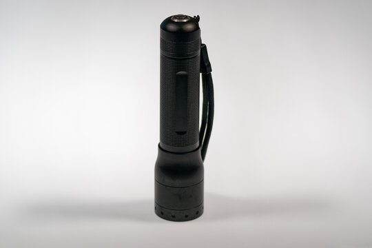Close-up of black metal flashlight led model Lenser P7R against white background. Photo taken June 22nd, 2024, Zurich, Switzerland.