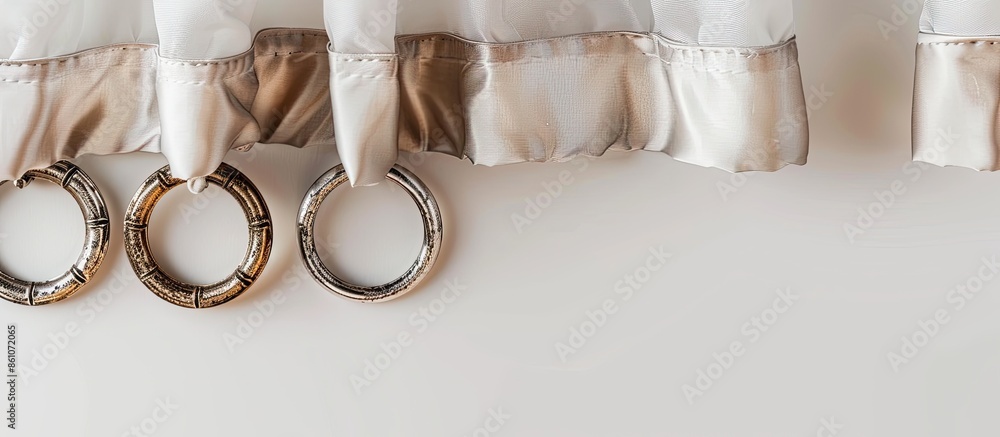 Poster metal rings for curtain rod on the white background. decorative rings for fixing the curtains to the