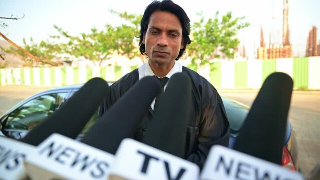 lawyer interviewed by news reporters outdoors