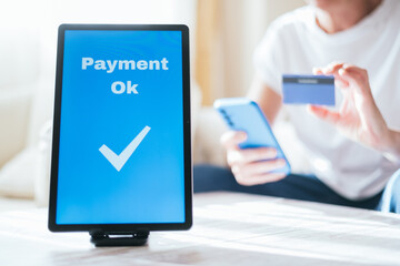 Successful Online Payment Confirmation on Tablet Screen. Payment OK message on a tablet screen with a checkmark.