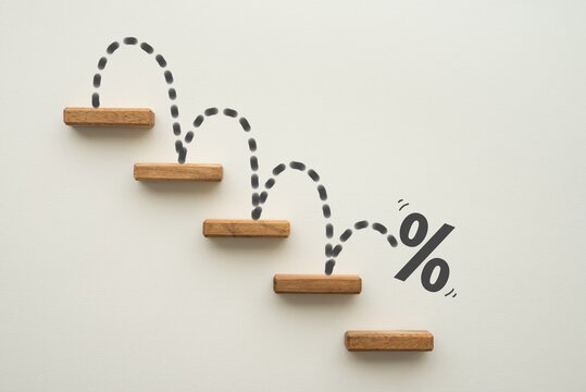 Percent sign moving down from top stair on white background. Central banking system of the United States FED (Federal Reserve System) cut interest rate, world finance and economy concept.