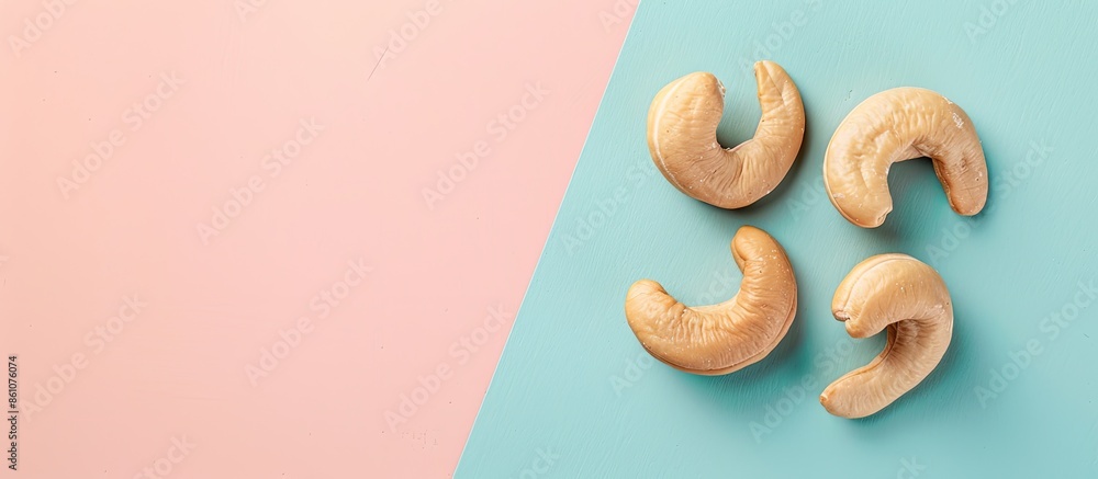 Poster Tasty organic cashew nut isolated on pastel background. with copy space image. Place for adding text or design