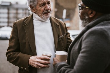 Senior men meeting in city street