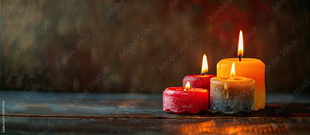 Poster Burning wax candles of different shapes on table. with copy space image. Place for adding text or design