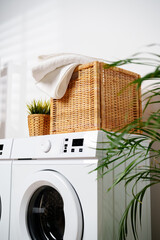 White Towels In Wicker Basket On Top Of White Washing Machine