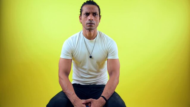 Confused man sitting on stool