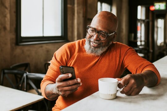 Bearded man checking social media oh his phone