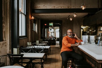 Man talking on the phone at a restaurant