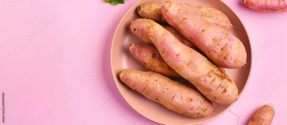 Poster Yacon roots plate isolated on a pastel background Yams. Copy space image. Place for adding text and design