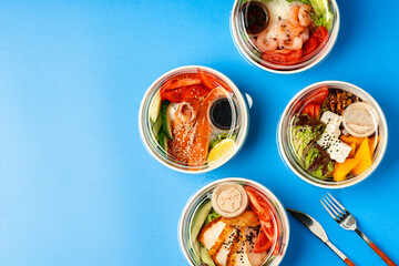 Different poke bowls on blue background top view