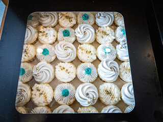 A box of cupcakes with colourful design.