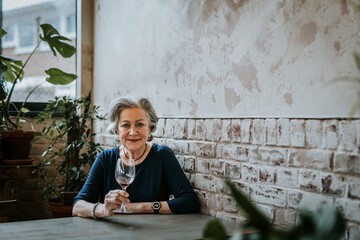 Senior woman holding empty wine glass