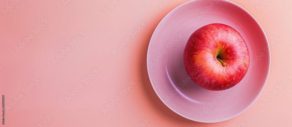 Poster ripe red apple in plate. isolated on a pastel background. copy space image. place for adding text an