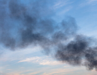 Black smoke from a fire against the sky