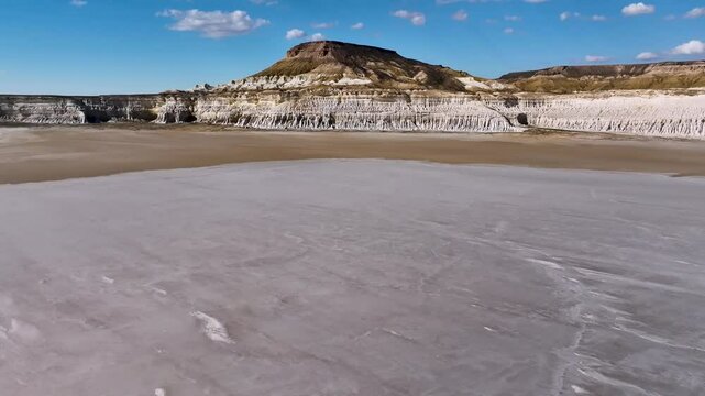 In summer, the water evaporates from Sor Tuzbair and the salt marsh becomes covered with a dense crust of salt on which you can walk. Mangystau Province, western Kazakhstan.