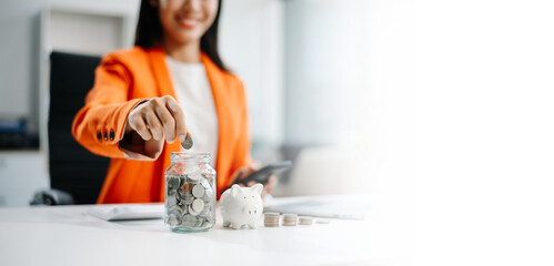 Hand putting mix coins and seed in clear bottle and business investment growth concept.