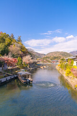 Naklejka premium Boats in Katsura River in Arashiyama district Kyoto,Japan.