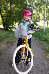 cute nine year old girl on the bicycle in the park