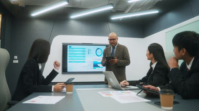 Happy diverse group Asian business team analyzing statistics financial. Group Team of business people meeting conference discussion various topic corporate concept in office.