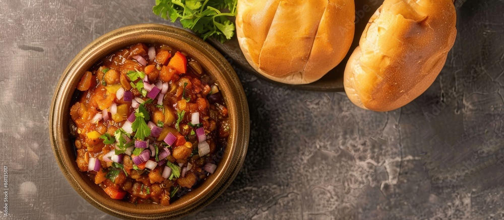 Poster indian mumbai food pav bhaji from vegetables with bread close-up in a bowl on the table. horizontal 