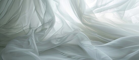 Fototapeta premium From the lower perspective, you can see how the transparent white curtain of the window smoothly blows the wind with beautiful wavy waves along with the curtains. The tulle necklace sways gently