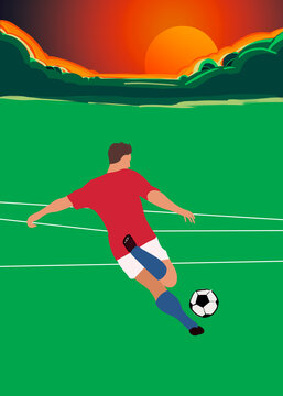 Soccer player kicking ball on field during sunset