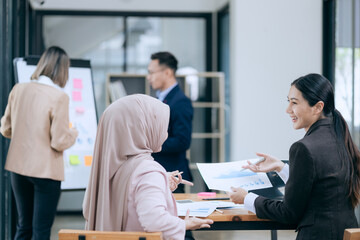 business engage in a brainstorming session, analyzing charts and diagrams. Colleagues, cheerful and proud, celebrate their achievements together.