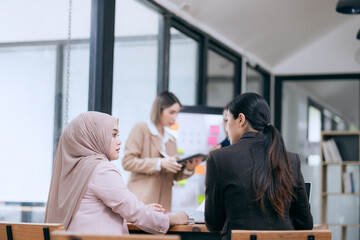 business engage in a brainstorming session, analyzing charts and diagrams. Colleagues, cheerful and proud, celebrate their achievements together.