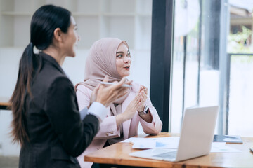business engage in a brainstorming session, analyzing charts and diagrams. Colleagues, cheerful and...