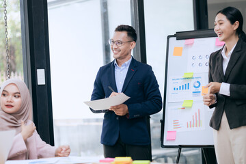 Professional business people taking part in a business meeting Discussing finances, strategies, and investing, they analyze charts on laptops. Demonstrate teamwork and effective communication.
