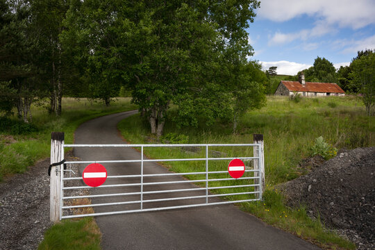 Fencing gate with warning sign prohibiting entry in forest