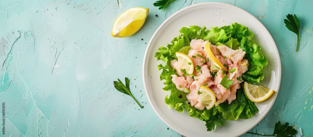 Poster pickled cod liver with lemon, fresh green lettuce on the white plate isolated pastel background. cop