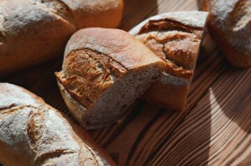 Freshly baked sourdough bread with a golden crust on bakery shelves. Baker shop context with delicious bread