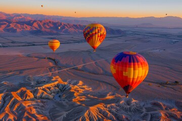 Naklejka premium Hot Air Balloons Soaring Over Dramatic Landscape