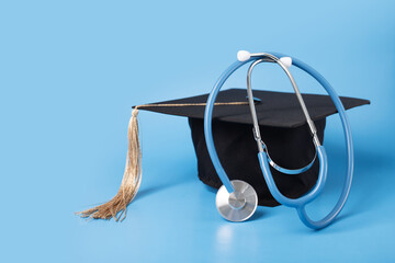 Medical education, graduation cap and doctor's stethoscope, graduate with diploma celebrating...