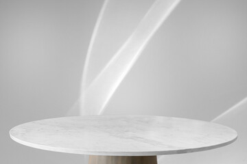 Round marble table top with abstract shadow drop on white wall background for mockup product display