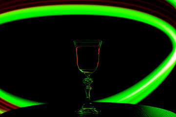 Uzależnienie od alkoholu koncept, kieliszek z winem w mroku, wpaść w sidła uzależnienia  © Paweł Kacperek