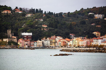 Fototapeta premium Lerici's Gulf of Poets photograph captures harbor, docked boats, and scenic coastal town ambiance