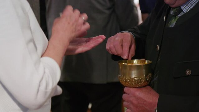 church attendants taking host at holy communion