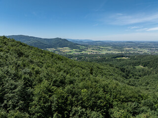 Obraz premium Drone fly above green mountains in summer. Polish green mountains and hills aerial drone photo. Drone view in Beskid mountains, Blatnia. Summer green forest on Blatnia. Beskid mountains in Jaworze.
