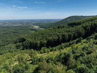 Obraz premium Drone fly above green mountains in summer. Polish green mountains and hills aerial drone photo. Drone view in Beskid mountains, Blatnia. Summer green forest on Blatnia. Beskid mountains in Jaworze.